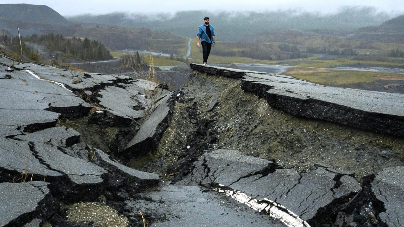 Road broken up by earth movements of earthquake